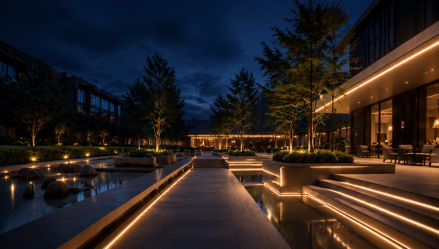 Warm integrated lighting along outdoor steps and landscaped paths at night
